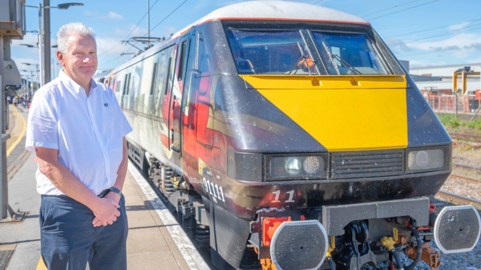 Nick Dudley, alongside a LNER Class 91 locomotive