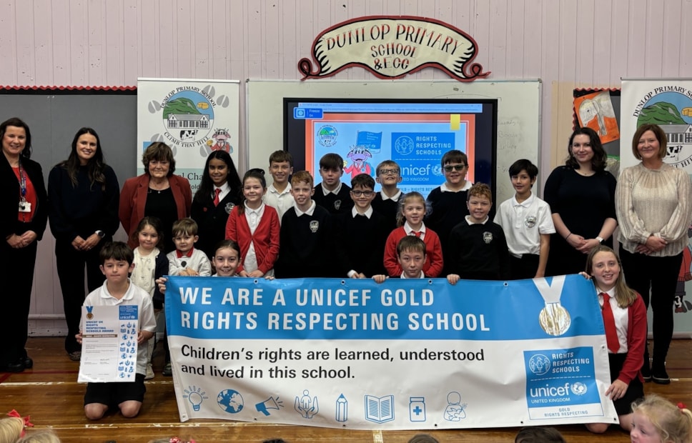 Head Teacher Laura Kelly with Cllr Freel, Mrs Bryce, Parent reps Mrs Salt and Mrs MacLellan , Katie and Ruaridh from the Dunlop ECC and the children involved in RRS