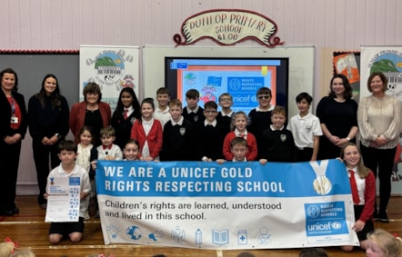 Head Teacher Laura Kelly with Cllr Freel, Mrs Bryce, Parent reps Mrs Salt and Mrs MacLellan , Katie and Ruaridh from the Dunlop ECC and the children involved in RRS