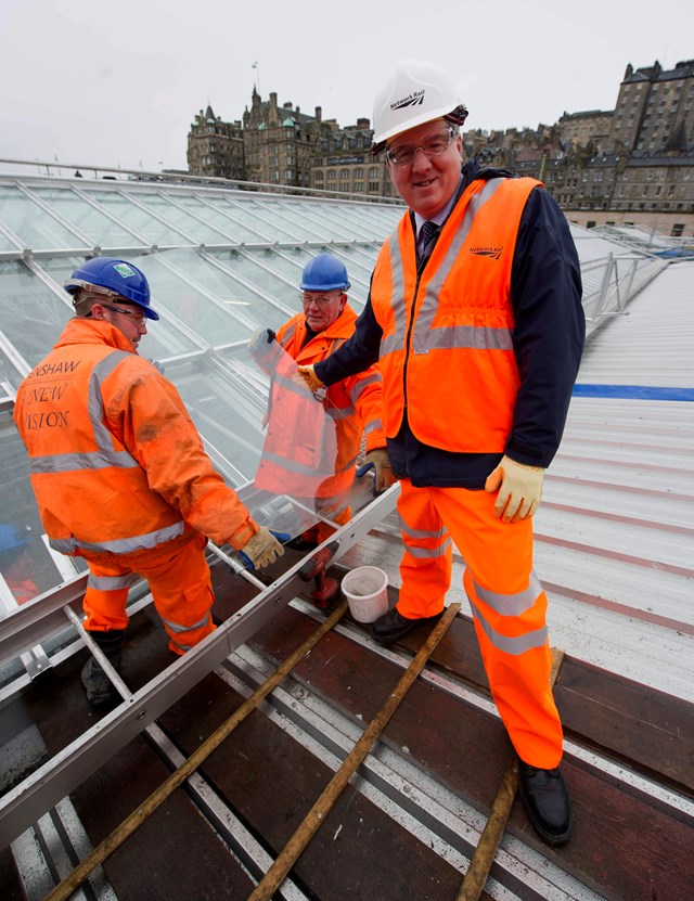 Waverley 1: Route managing director David Simpson lends a hand as glaziers fit the last of 24,700 panes of glass in Edinburgh Waverley's new roof.