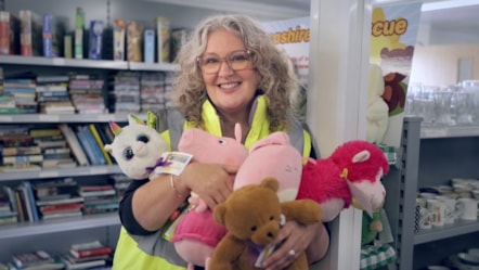 Janine from Lancashire County Council shows off some of the great items at the reuse shops