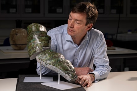 Curator Dr Fraser Hunter with the Roman arm guard. Photo (c) Duncan McGlynn (10)