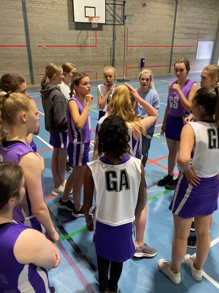 Forres Academy Active Schools volunteer netball coach Hannah Rogan leads the team talk.