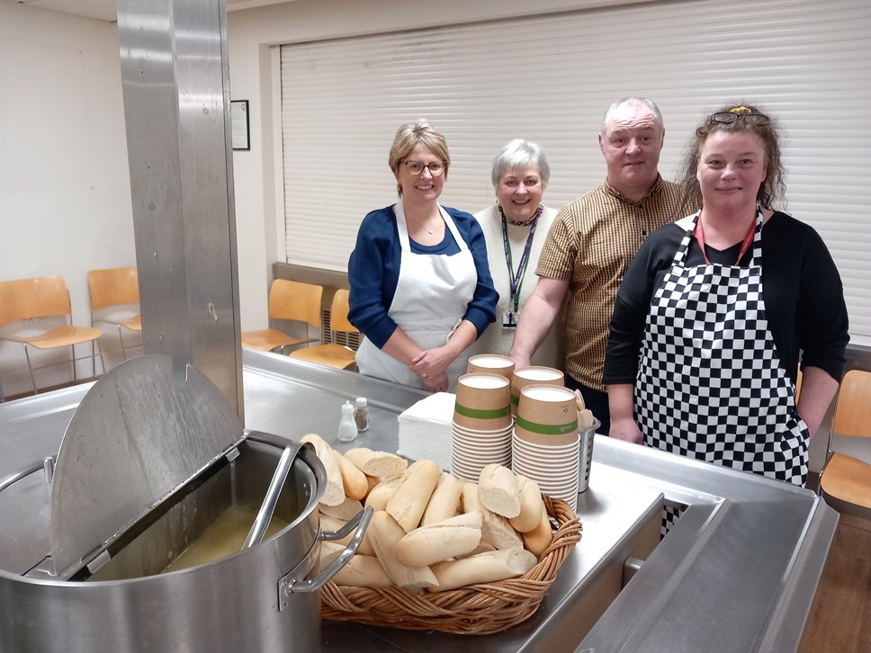 Council catering staff volunteers (three women and a man) with soup and bread.