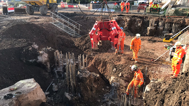 Network Rail and BAM Nuttall engineers digging out the ground underneath platform 15