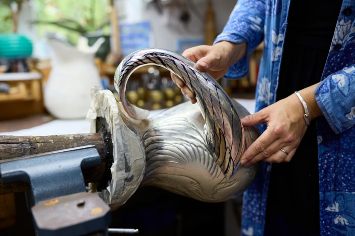 Reflections in Silver: Artist Miriam Handid has been crafting her Phoenix Jug piece in her Suffolk workshop after being inspired by the birds of Temple Newsam, in particular an 18th century side table designed by John Vardy and the Chinese Drawing Room wallpaper featuring birds cut from John James Audubon’s book The Birds of America. Credit Leeds Museums and Galleries Nick Singleton.