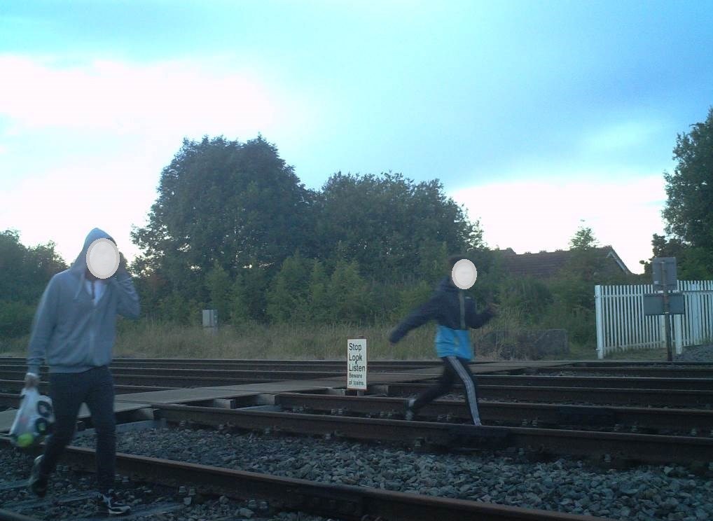 Two boys wonder down the tracks at Gobowen