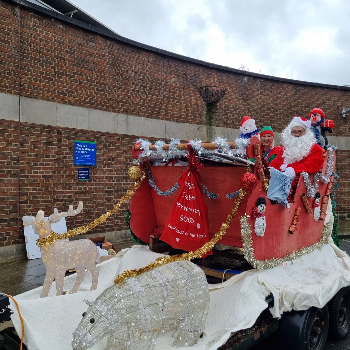 Santa and his elf in a sleigh made by Northern colleagues