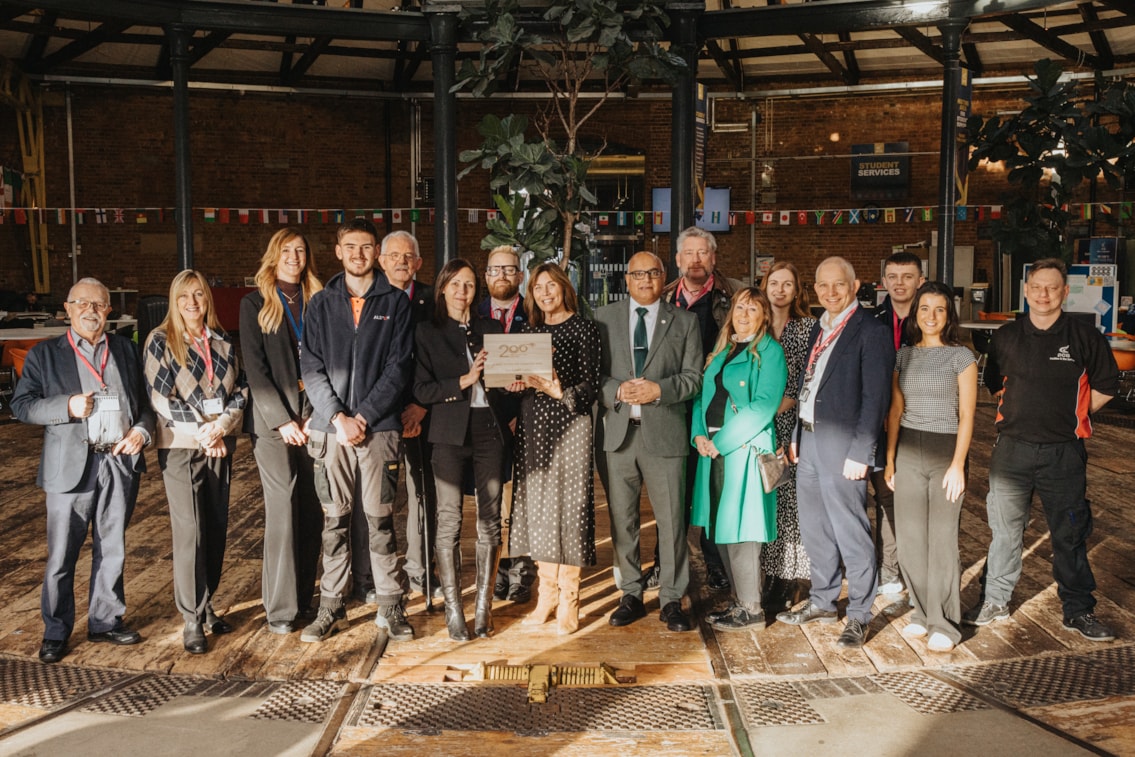 Rail industry staff, some of the Railway 200 team and Derby College staff with the time capsule 