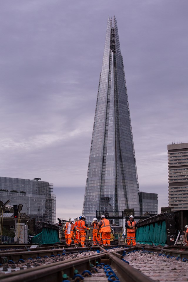 London Bridge August 2015: The Shard looms over rail workers working on the viaduct at Ewer Street, Southwark, putting in a new set of points for the Thameslink Programme