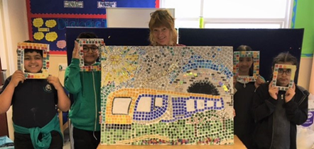 This image shows Frizinghall pupils with their train mosaic