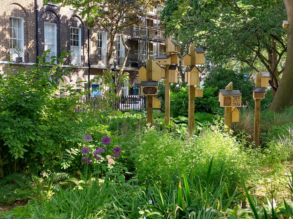 Bird boxes and insect hotels nestling amongst foliage and trees at Duncan Terrace Gardens