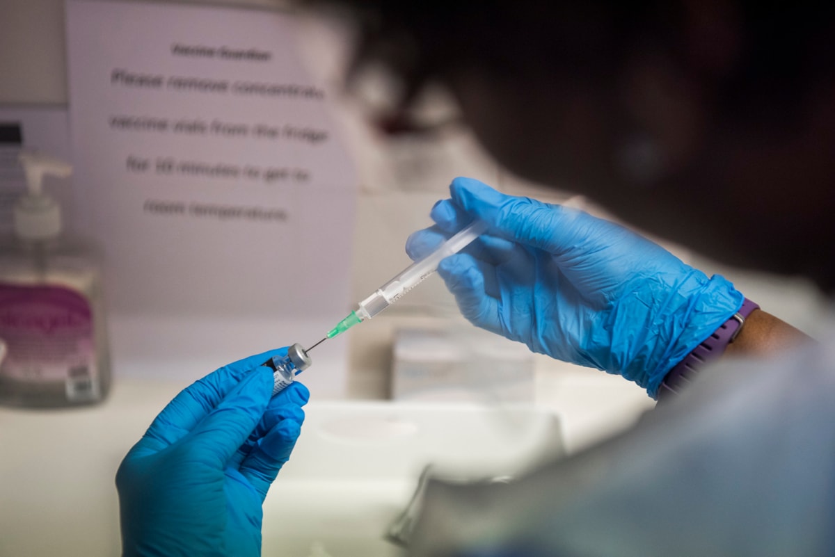 Hackney nurse draws up the covid-19 vaccine into a syringe