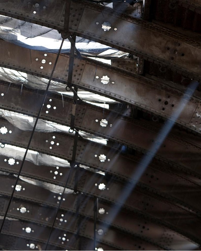 Sunlight through Paddington's Span 4: Sunlight creeps through the deteriorating roof of Span 4. Netting was put in place to protect workers from falling glass as they carry out renovation work.