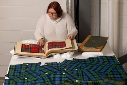 A University of Glasgow students examines the tartan samples. Photo © Duncan McGlynn (1)