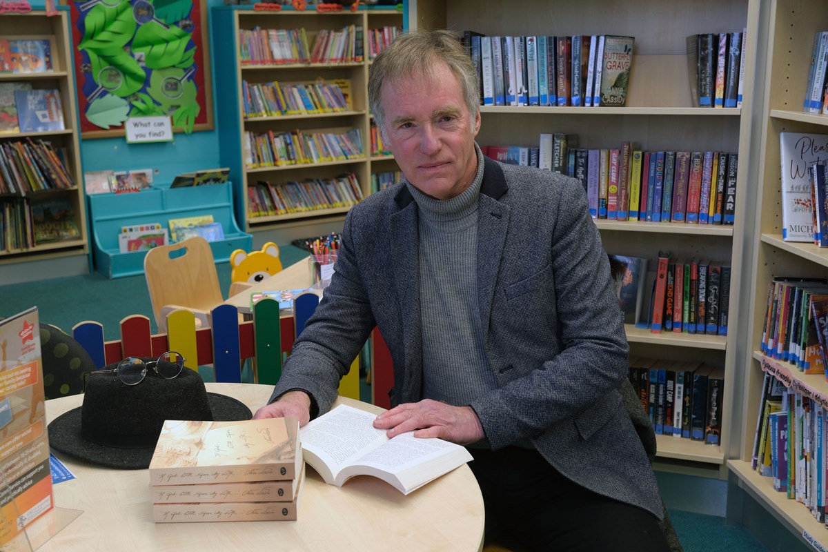 Author Mike Lewis with copies of his book