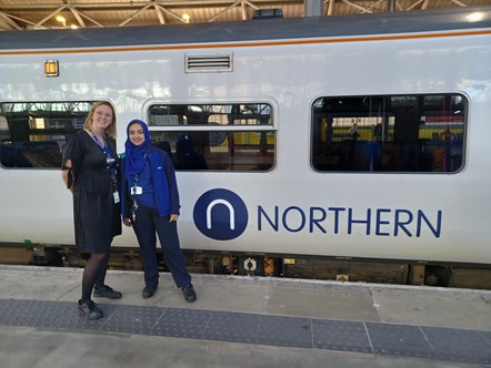 Zahida stands with her manager Kelly Dodsworth next to a Northern train