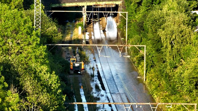 Network Rail engineers surveying flood waters after water main burst