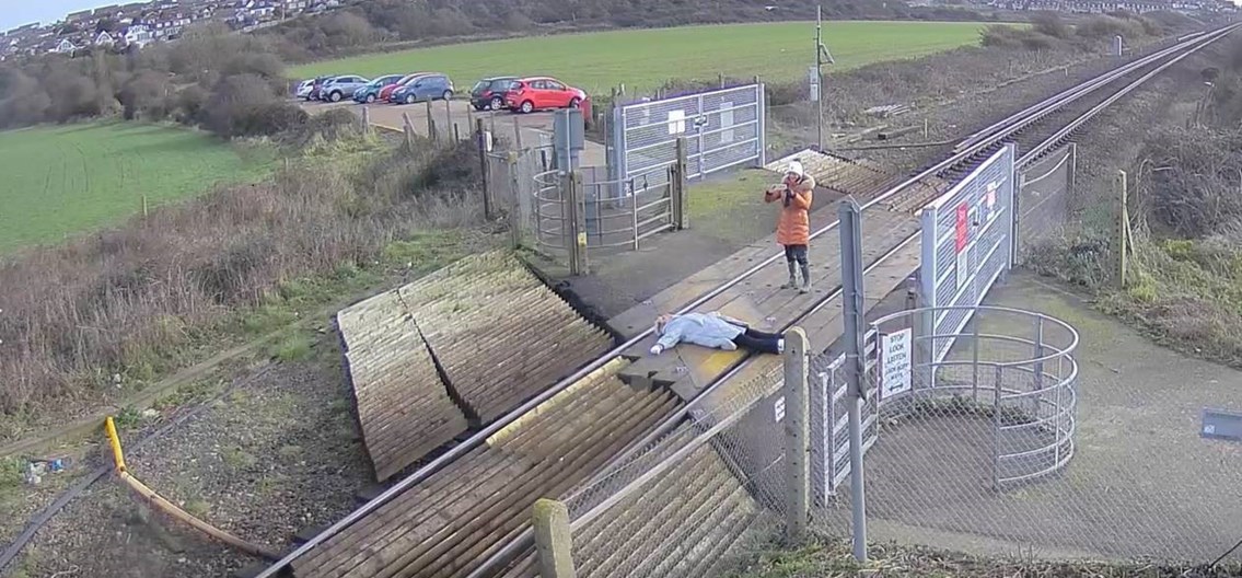 Network Rail is urging people to stay safe at level crossings after shocking CCTV footage showed a woman laying on railway tracks to pose for photographs: Misuse at Tidemills level crossing