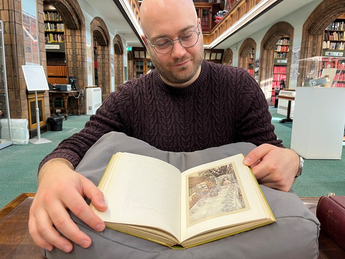Fantasy at Leeds Central Library: Librarian Josh Flint with a vintage copy of Alice's Adventures in Wonderland which features in Leeds Central Library's new Fantasy exhibition.