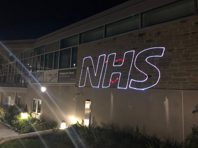 NHS lit up on the Tamar bridge