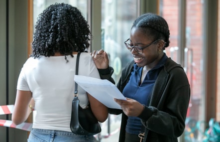 Zora, a student from Cardinal Pole, smiling as she looks at her GCSE results