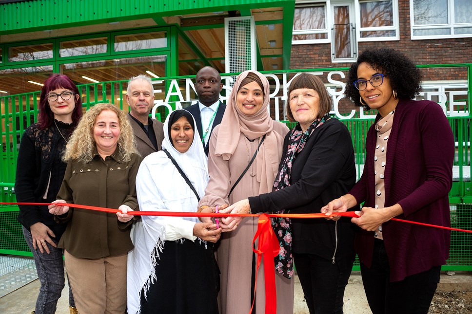 Councillors, staff and residents cutting a ribbon to open Jean Stokes Community Centre