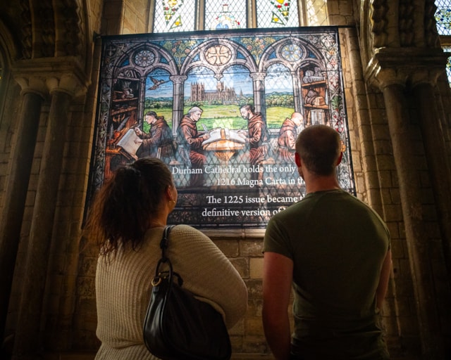 Visitors viewing the contemporary artworks as part of Magna Carta and the North exhibition at Durham Cathedral