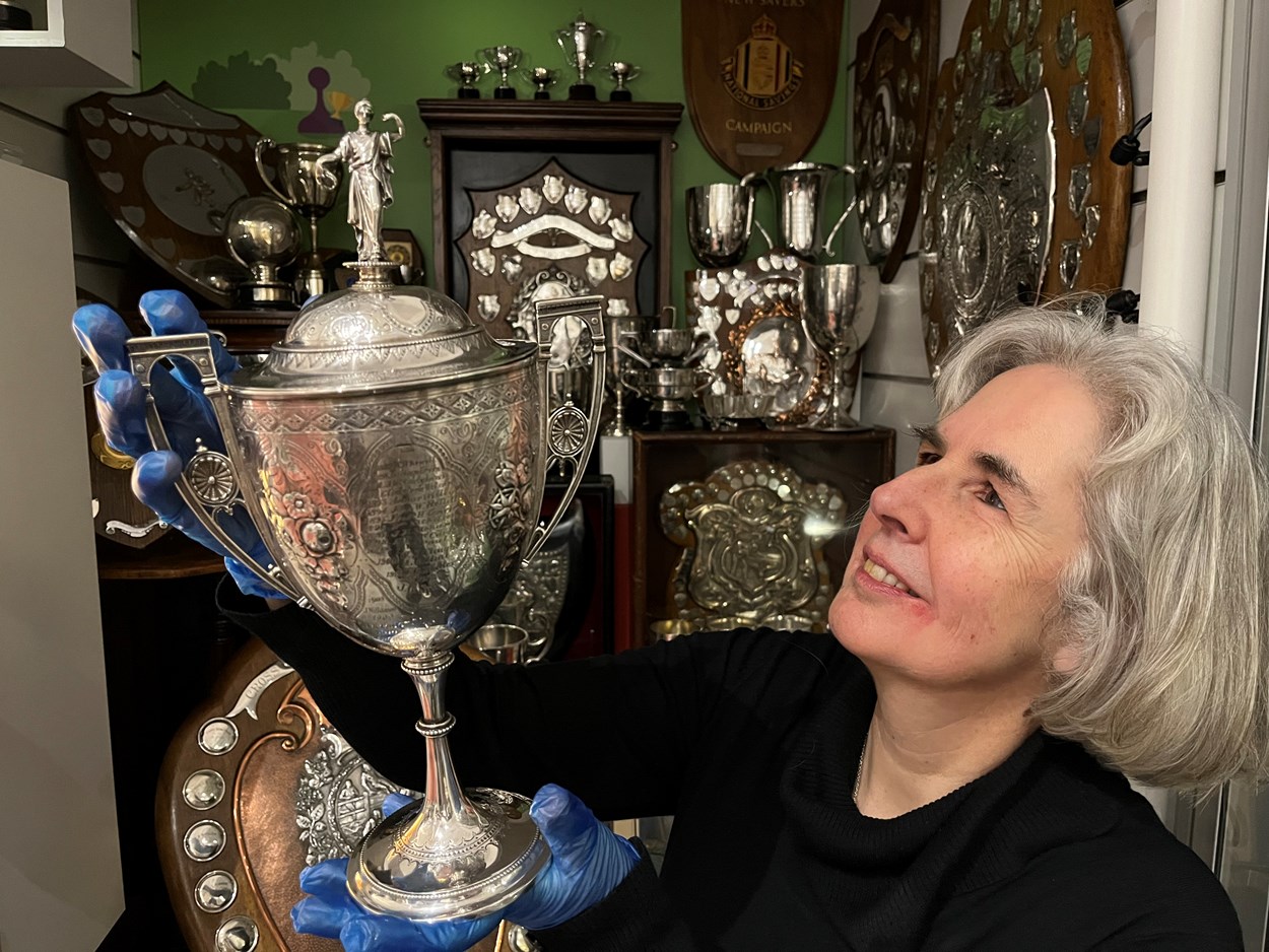 All to Play For: Kitty Ross, Leeds Museums and Galleries curator of social history with a dazzling cabinet stuffed with accolades awarded for everything from darts and billiards to hairdressing and rose-growing which are on show as part of the exhibition.