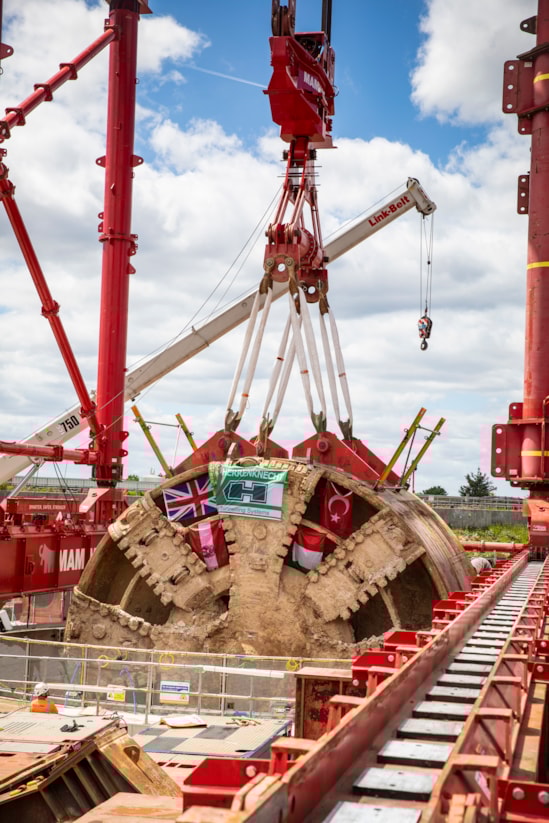 TBM Caroline lifted out of vent shaft at Green Park Way, Greenford - May 2025-7: HS2 lifts Tunnel Boring Machine (TBM) ‘Caroline’ from below ground at the Green Park Way site in Greenford, West London.

On Sunday 25th May, engineers working on the HS2 project lifted the TBM 9.48metre diameter cutterhead, front and middle shield, weighing 850 tonnes, using a large gantry crane. The tunnelling machine concluded its 5mile journey from West Ruislip in April, arriving in an underground reception chamber. TBM Caroline excavated over 1.2 million tonnes of earth and installed 4,217 tunnel rings.