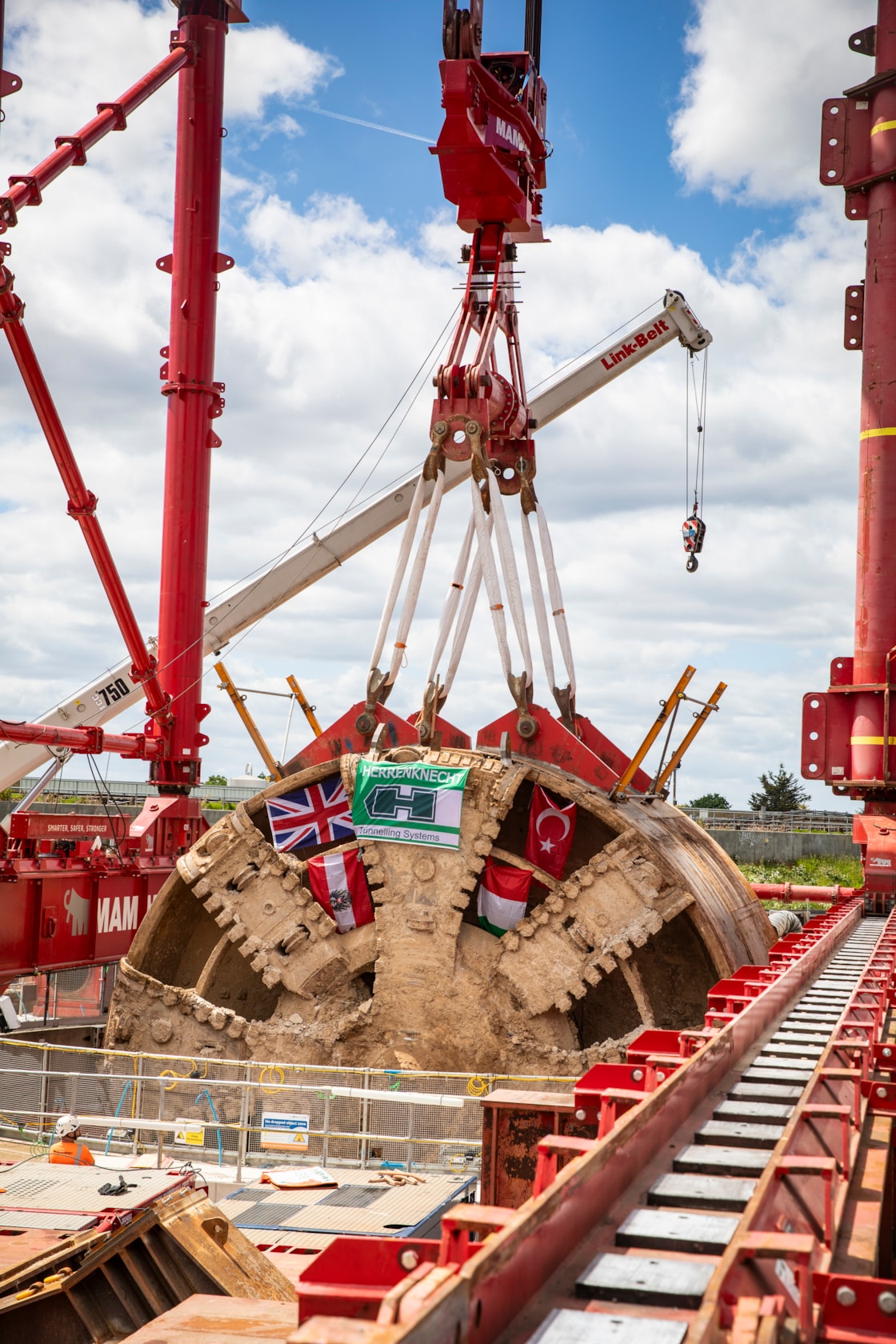 TBM Caroline lifted out of vent shaft at Green Park Way, Greenford - May 2025-7: HS2 lifts Tunnel Boring Machine (TBM) ‘Caroline’ from below ground at the Green Park Way site in Greenford, West London.
On Sunday 25th May, engineers working on the HS2 project lifted the TBM 9.48metre diameter cutterhead, front and middle shield, weighing 850 tonnes, using a large gantry crane. The tunnelling machine concluded its 5mile journey from West Ruislip in April, arriving in an underground reception chamber. TBM Caroline excavated over 1.2 million tonnes of earth and installed 4,217 tunnel rings.