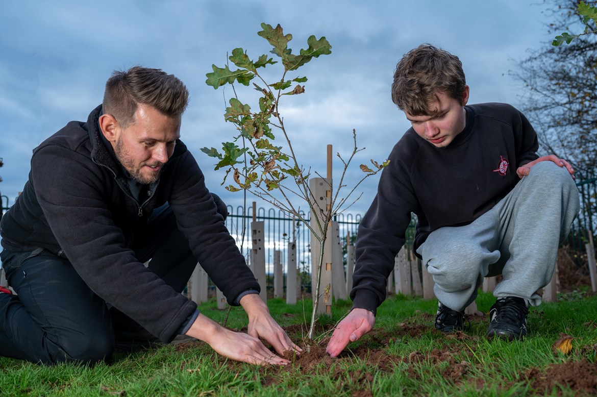 HS2 donates 300 trees to Coventry school for Queen’s Green Canopy initiative: James Hicks, Biodiversity Specialist at HS2, with a Corley Academy student