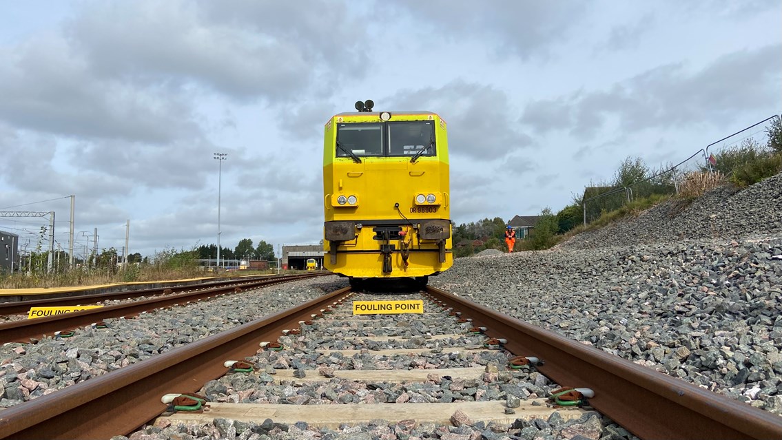 Track level view of autumn treatment train in sidings at Wigan