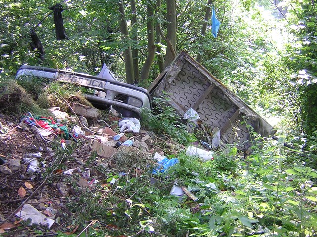 Fly-tipping - Surbiton, Surrey: An example of amount of rubbish dumped on railway land.  
Location: behind a disused pub, Surbiton, Surrey.
Photo taken June 2006