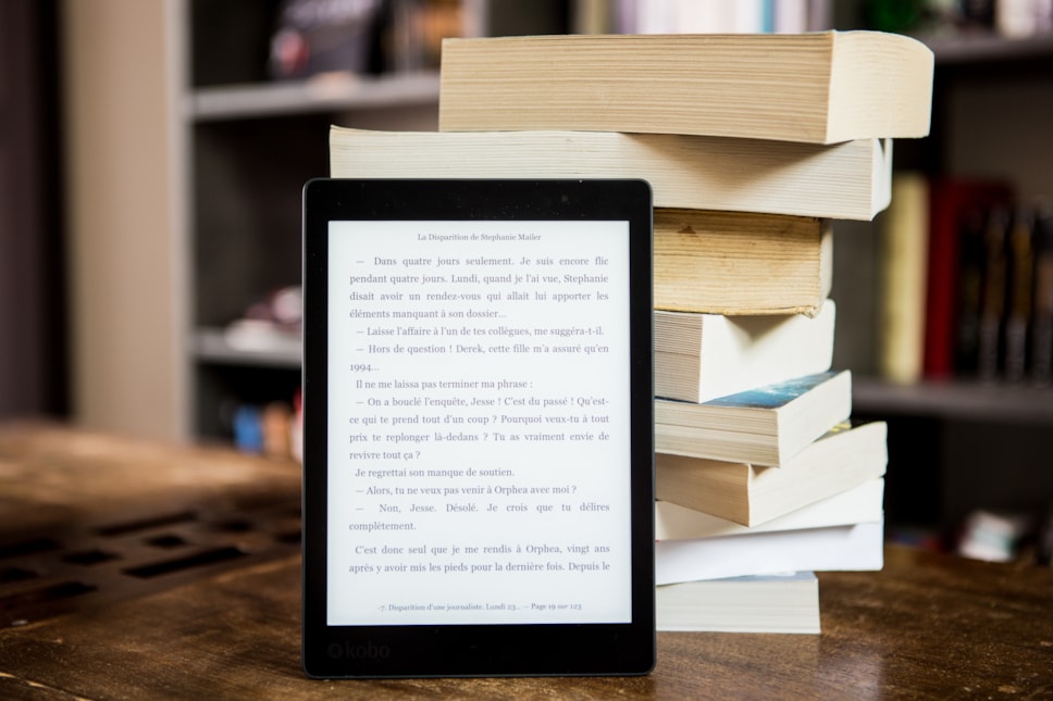 black-tablet-computer-behind-books-1329571