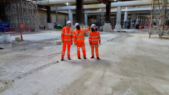 Foundations complete for HS2's Old Oak Common high speed station: Workers walk across the competed base slab in the 850m long underground station box at Old Oak Common. L-R: Russell D'Urso, HS2 Project Manager, Raj Alagenthirarajah – Expanded Senior Site Engineer, Kitty Bulmer- BBVS Assistant Package Manager