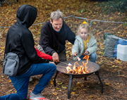 Party for Hilsea - Marshmallow roasting: Photo taken at Party for Cosham in 2022. Image shows a father roasting marshmallows with his three children.