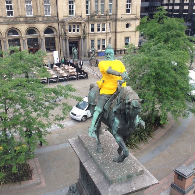 Leodis TdF gallery: The famous Black Prince statue on City Square in Leeds was dressed in a yellow jersey ahead of the Grand Depart in July, 2014. The jersey was result of weeks of hard work by older people attending Holbeck Elderly Aid and Holt Park Active. Around 30 balls of yellow wool were used for the Black Prince’s two metre-long jersey, which was lifted into place before being carefully stitched on. Credit Leeds City Council