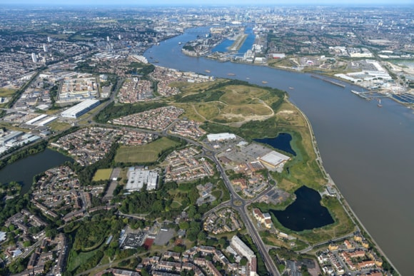 Have your say on new plans to extend the Docklands Light Railway (DLR) to Beckton Riverside and Thamesmead: Image - Aerial view of development area across the river