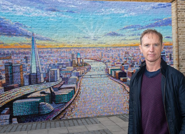 Artist Jimmy C with his work at Blackfriars