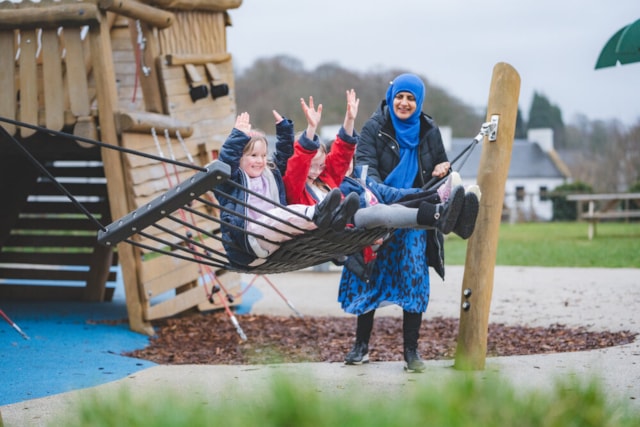 Childminder with children at a play park (image supplied by Scottish Childminding Association)