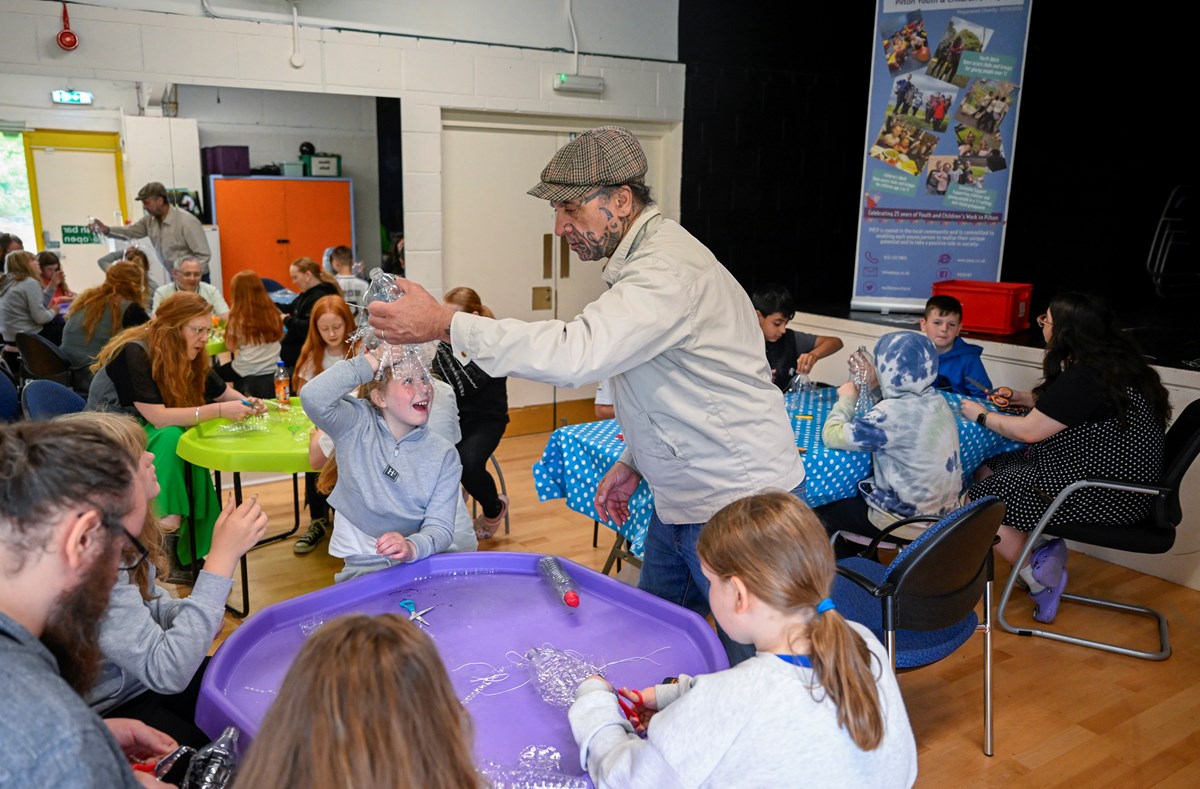Artist George Nuku working with young people from the Pilton Youth and Children's Project and Granton Youth on components for the artwork Bottled Ocean 2123, an imagined underwater landscape made from recycled plastic. The work will go on show in the exhibition Rising Tide: Art and Environment in Oceania, which opens on August 12 at the National Museum of Scotland. Image credit: Neil Hanna.
