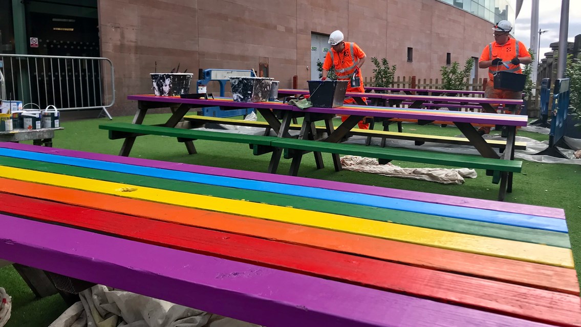 Network Rail workers painting the benches for Manchester Pride