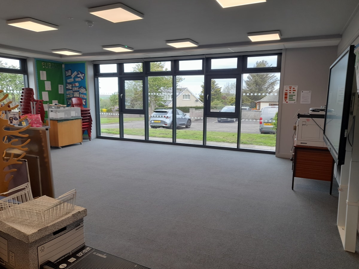 Refurbished classroom at Cullen Primary School, featuring floor-to-ceiling windows, improved lighting and new flooring.
