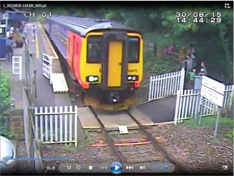 Matlock Bath - Gates lodged open while a train goes over the crossing