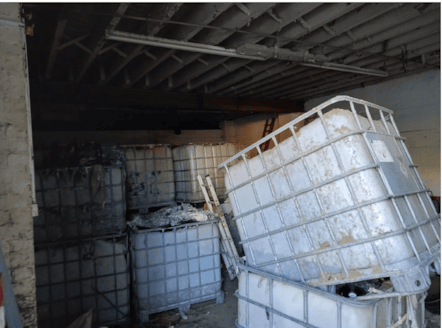 IBCs containing waste, namely stripped coatings, in left hand side of unit (as facing)