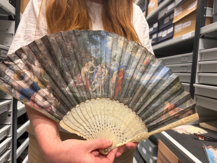 Antique fans: Curator Natalie Raw holds a stunning 350-year-old fan depicting a legendary scene from the Trojan War which is being conserved at Leeds Discovery Centre.
Crafted in around the 1680s, the beautiful folding hand fan, complete with sticks carved from antique ivory, captures The Judgement of Paris, a fateful mythical moment which saw the Trojan prince choose which of three ancient goddesses- Hera, Athena, or Aphrodite- was the most beautiful.