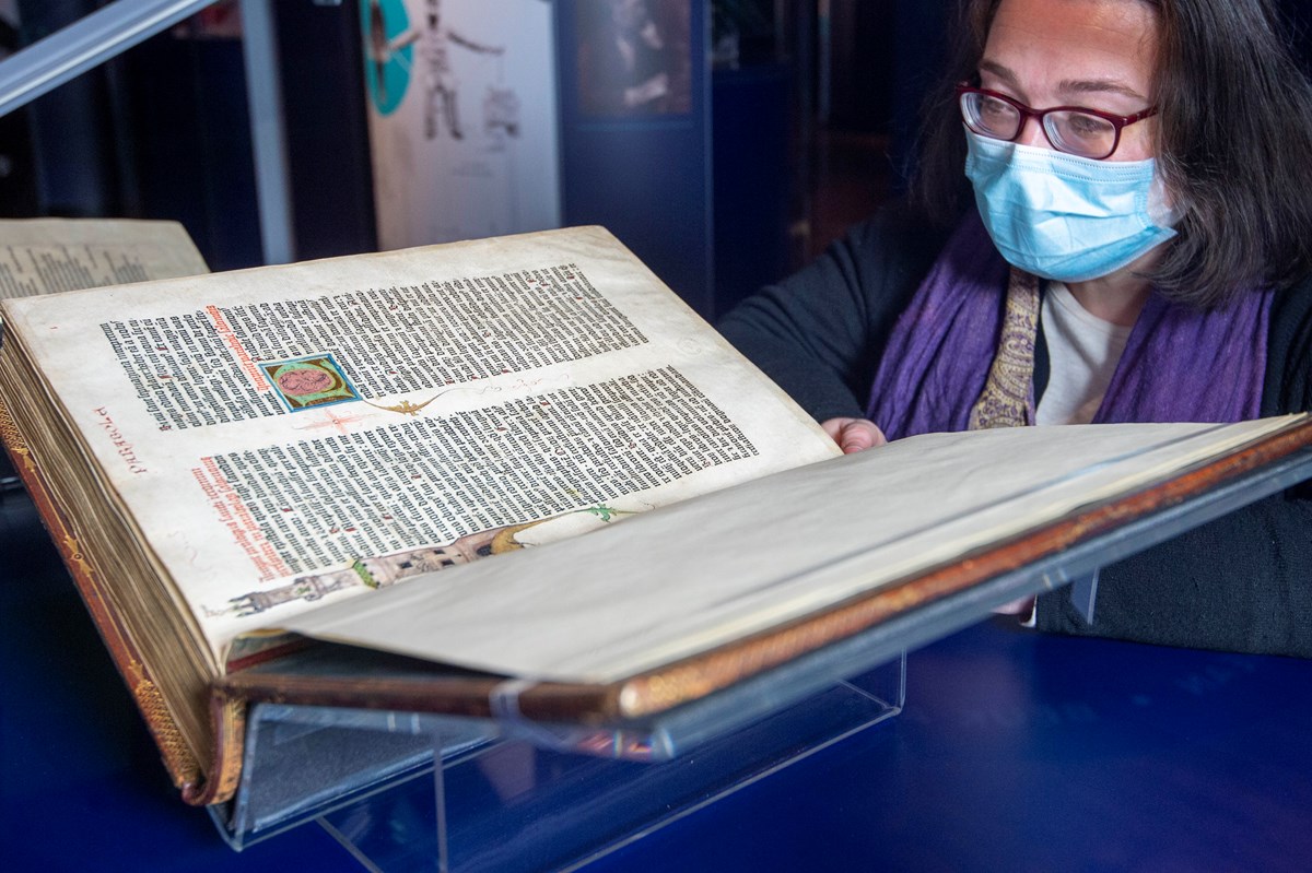 Head of Rare Books Helen Vincent with the Library's copy of the Gutenberg Bible. Credit: Neil Hanna