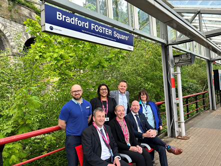 This image shows Northern and Bradford Childrens & Family Trust staff under the tempary signage for Bradford Foster Square which has been changed from Bradford Forster Square