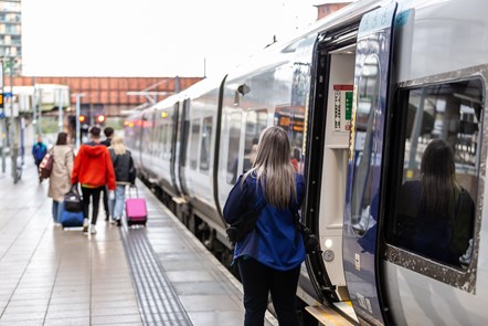 Image shows a family boarding a Northern train